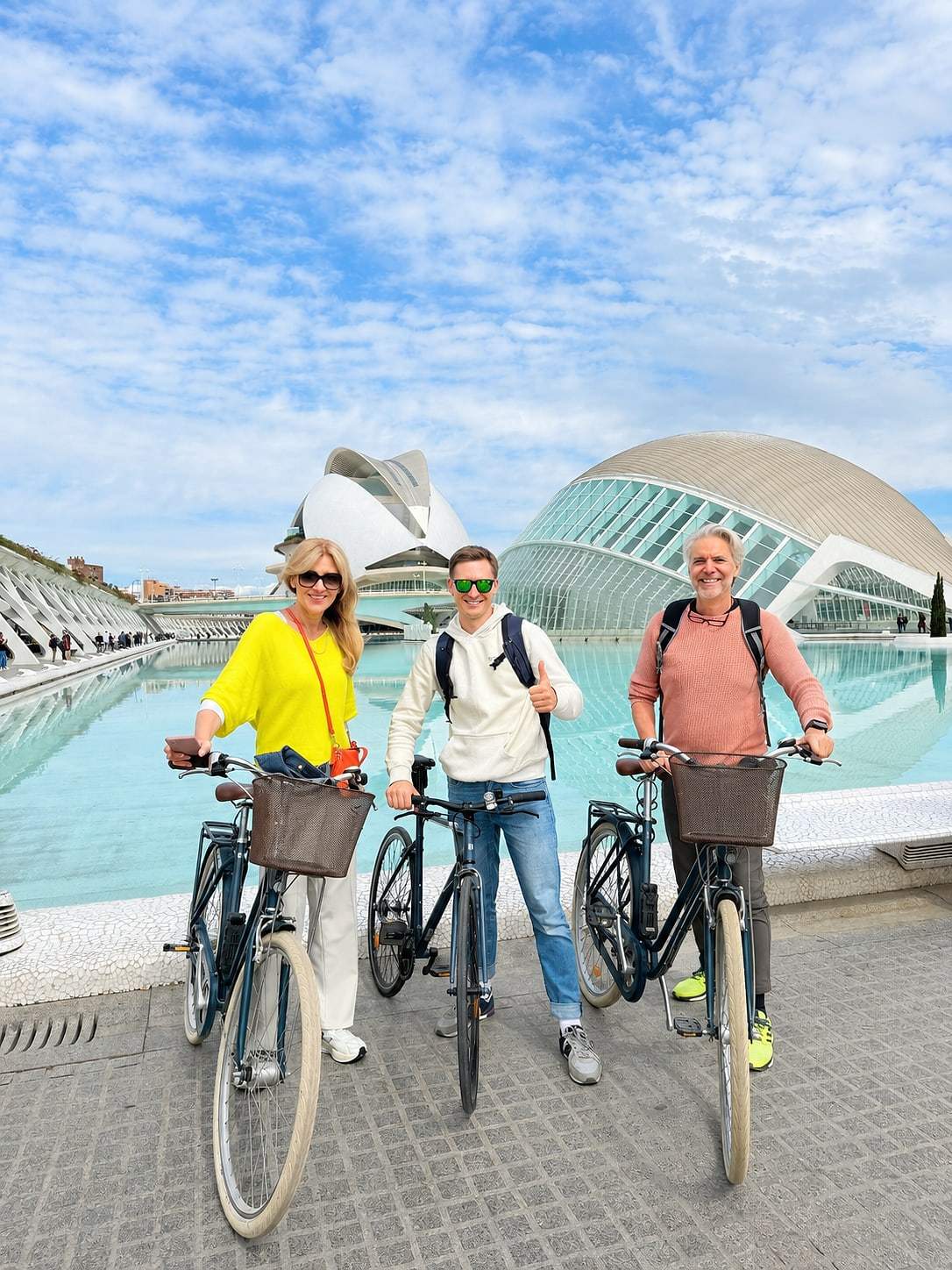 Guests posing with their bikes on a sunny day
