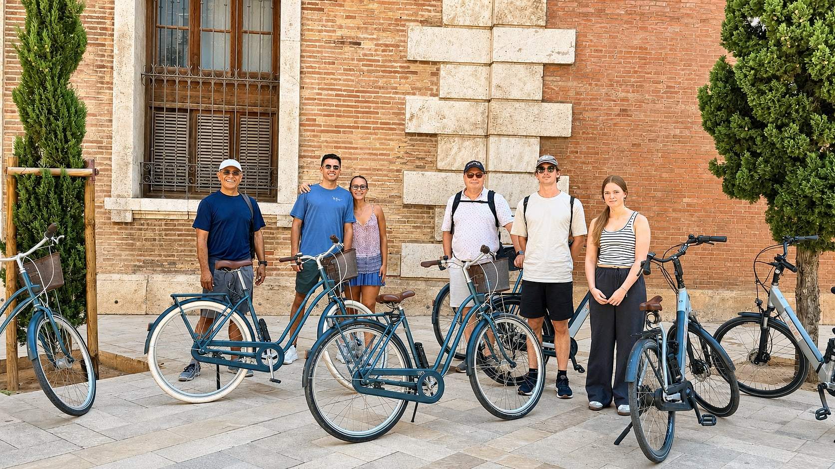 The group pauses in front of a Valencia landmark