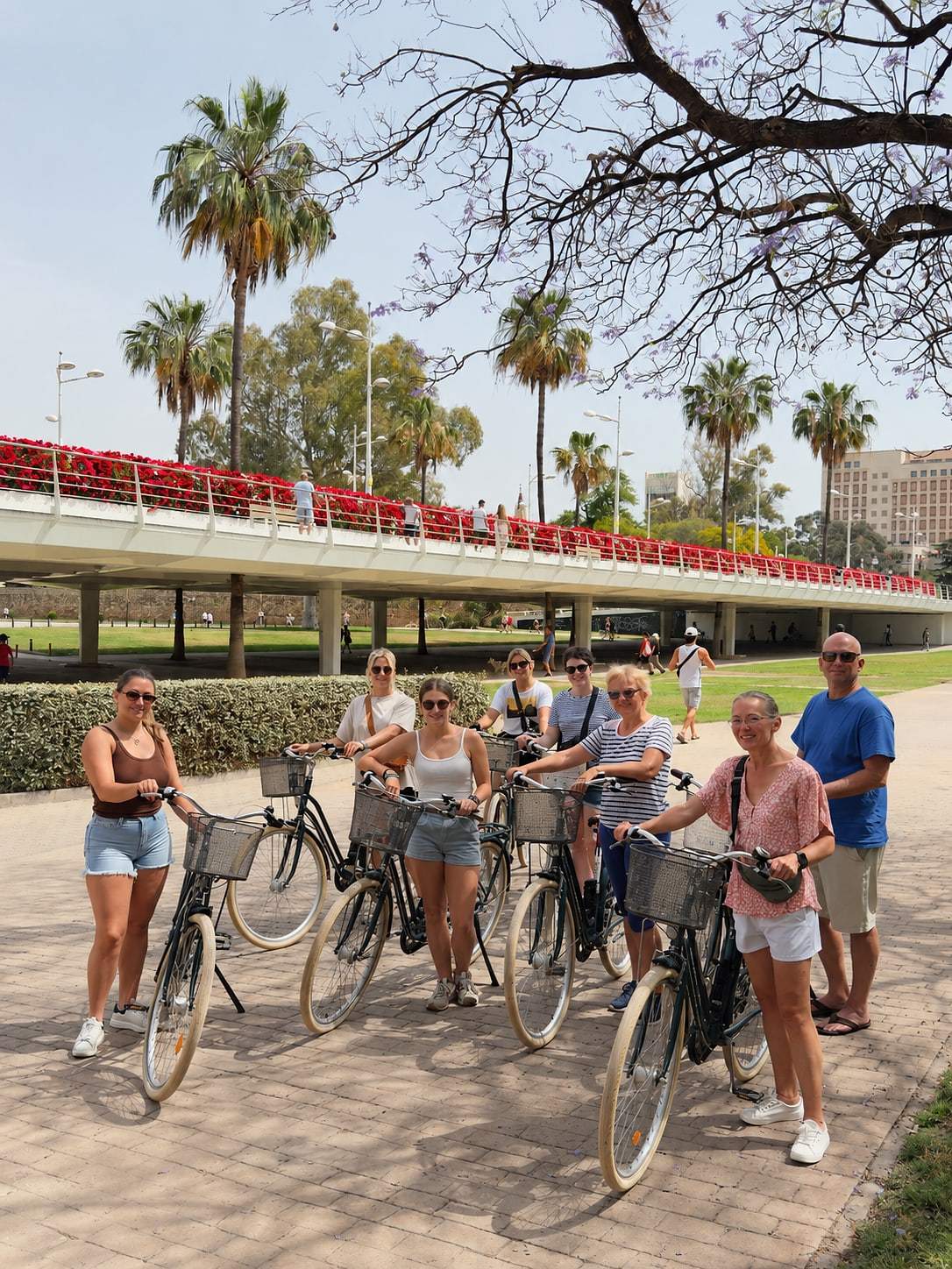Guests posing with their bikes on a sunny day