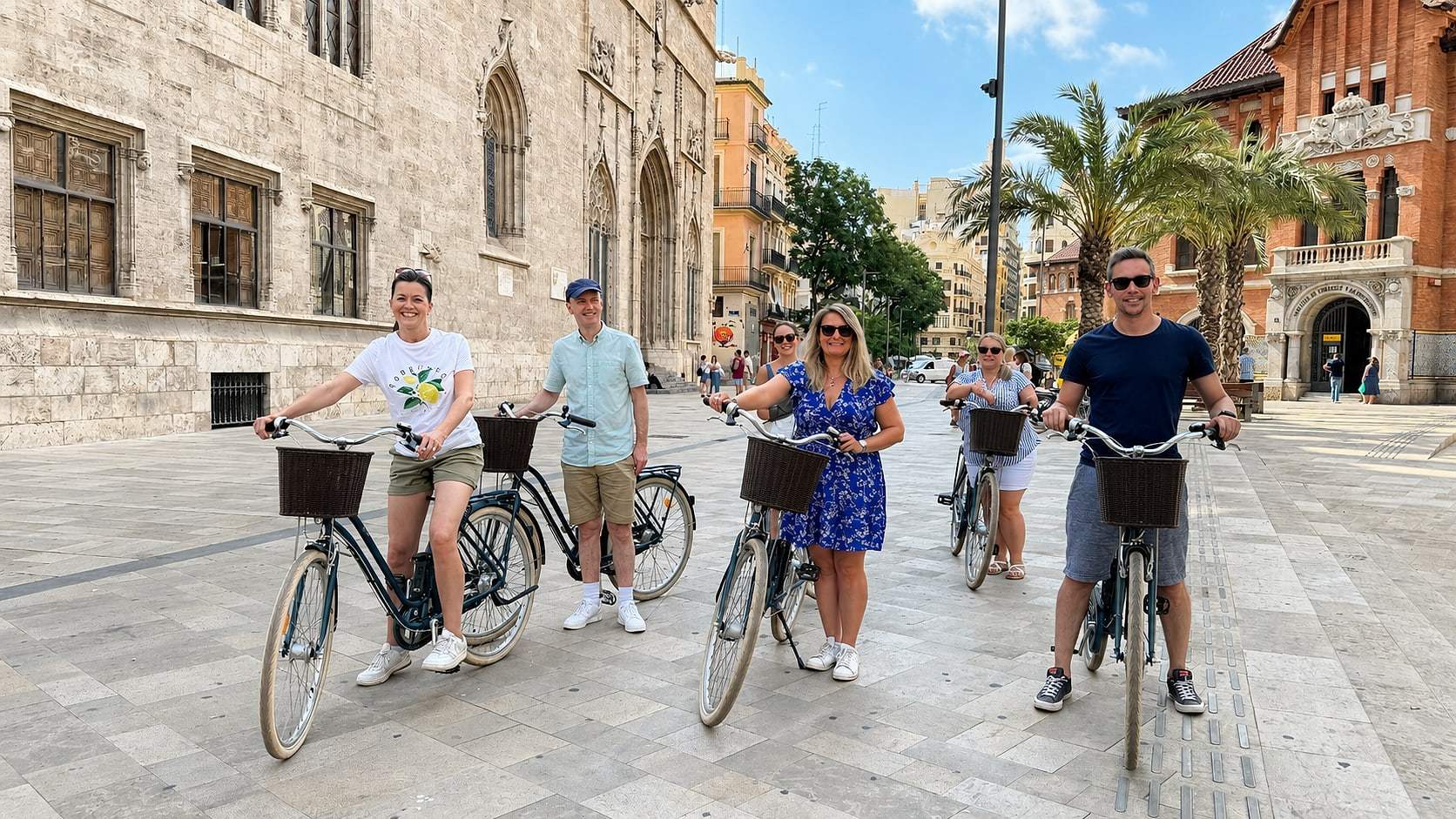 The group pauses in front of a Valencia landmark