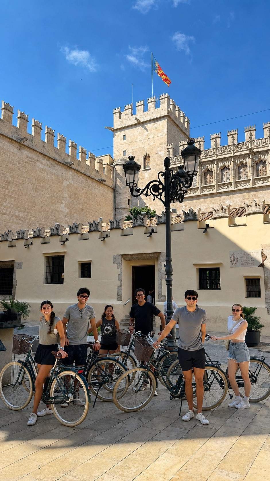 Guests posing with their bikes on a sunny day