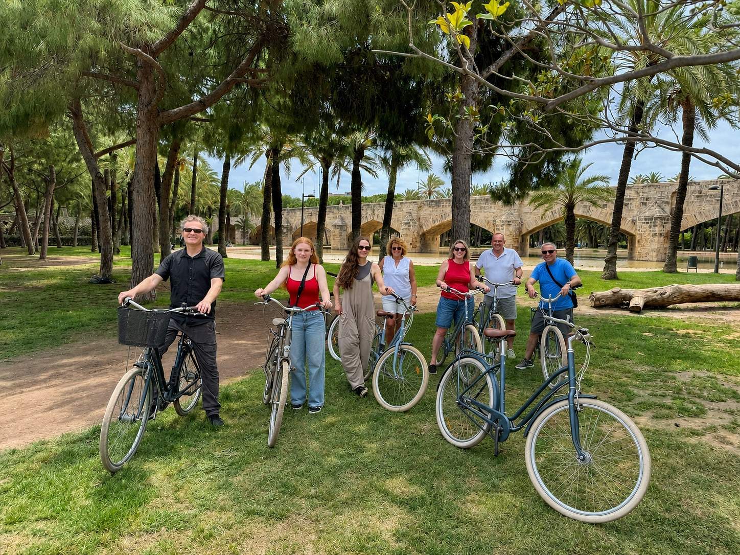 Guests posing with their bikes on a sunny day